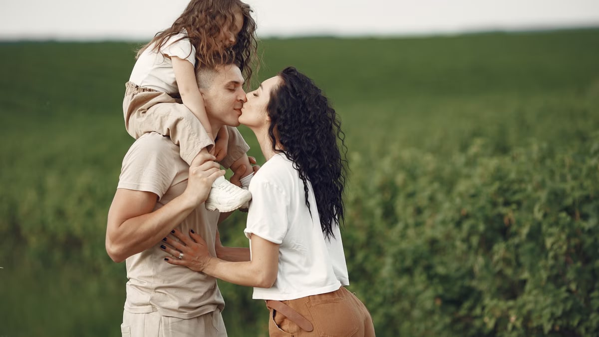 A heartwarming family moment captured in a field, highlighting love and togetherness.